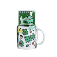 Ceramic mug set: white mug with green monster face and roaring text, handle visible
