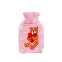 Pink knit hot water bottle cover with cute bear face and heart pattern