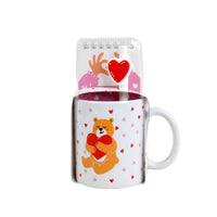 Ceramic bear mug with hearts and paw-print design, with clear gift sleeve and lid