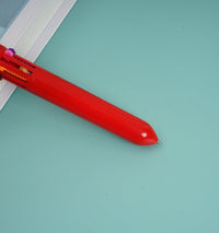 Red Santa Claus 6-color pen, side view showing color window and nib section