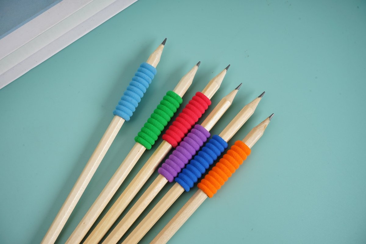 Six colored wooden pencils fanned out, with blue, green, red, purple and orange tips