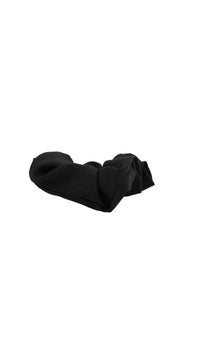 Black fabric hair scrunchie laid flat, gathered elastic band