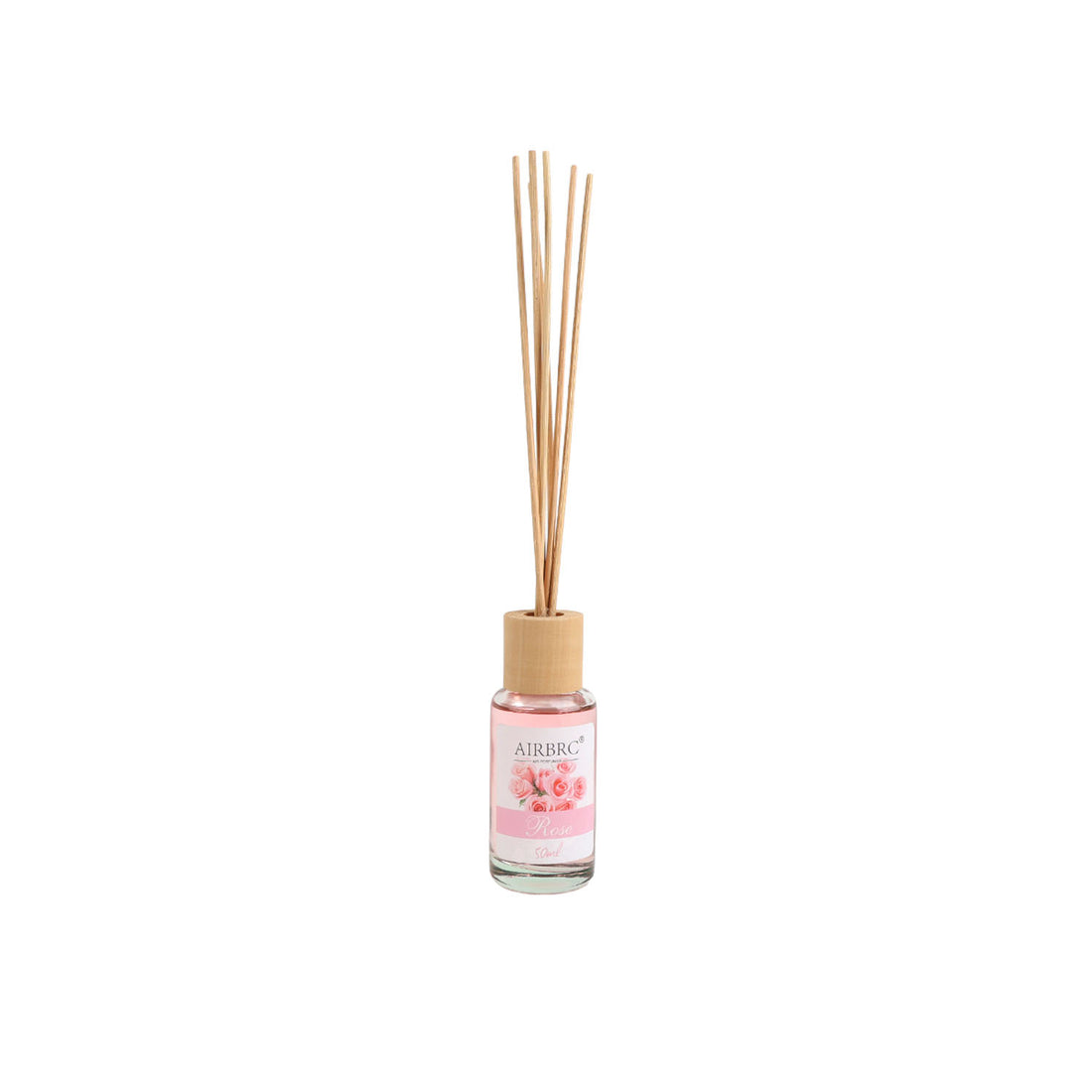 Pink reed diffuser bottle with natural wood cap and multiple light reeds