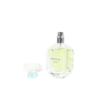 Women's perfume bottle with silver cap; faceted glass shows light yellow perfume