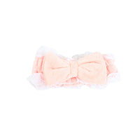 Plush hair band with bow in light pink, soft fabric and ruffled trim
