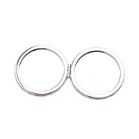 Round double-sided compact mirror with two chrome circles, closed