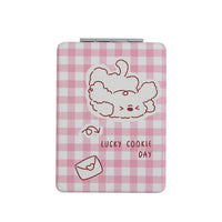 Square double-sided compact mirror with pink gingham cover and puppy line-art design