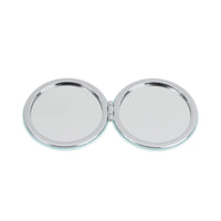Pair of round mirror faces in double-sided compact, chrome frame