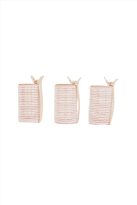 Three light pink hair rollers with beige clips, side-by-side view
