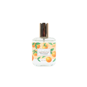 Eau de toilette spray bottle with gold cap and orange fruit leaf label