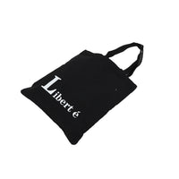 Black canvas shoulder bag with 'Liberté' lettering and strap