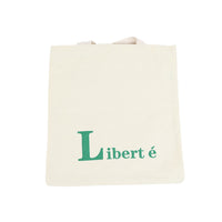 Cream canvas shoulder bag with green 'Liberté' lettering