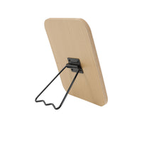 Light wood square mirror with black wall/stand hardware on the back