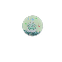 Round mint green compact mirror with cute dinosaur illustration and glitter border