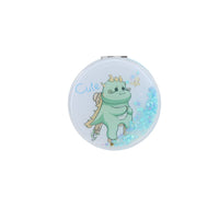 Round light blue compact mirror with cute dinosaur illustration and holographic glitter