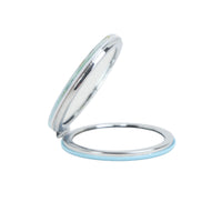Round compact mirror case open, showing reflective mirror surface and blue trim