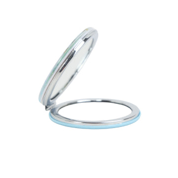 Round compact mirror case open, showing reflective mirror surface and blue trim