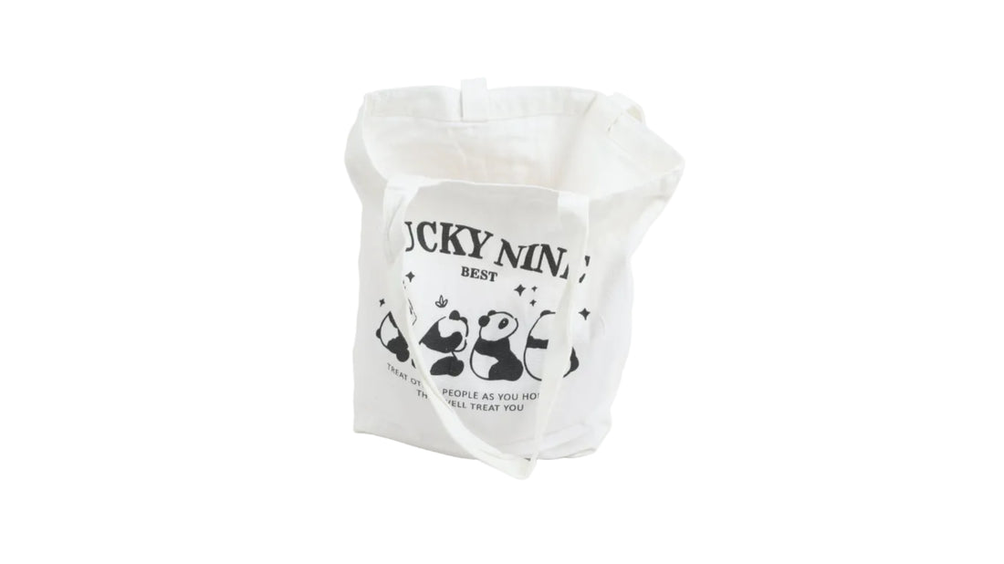 White canvas open-top shoulder bag with panda graphic and text print