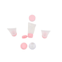 Pink travel squeeze bottles and matching caps, five-piece set, unboxed