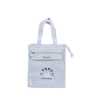 Light blue insulated tote-style lunch bag with front zipper pocket and YUMI cartoon.
