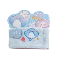 Ocean-themed plush headband, light blue with dolphin and star patches