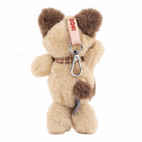 Beige and brown plush dog keychain with metal clip, fabric loop and red tag