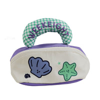 Purple plaid ocean makeup bag with curved handle and dolphin and star patches.