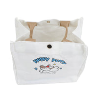 White handheld bento bag with dog cartoon graphic and buttoned top