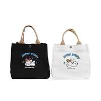 Set of two handheld bento bags: black and white, each with Happy Puppy dog graphic