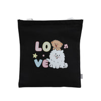 Black canvas shoulder tote bag with 'Love' dog illustration, stars, and musical notes