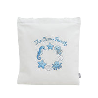 White canvas tote with blue ocean fairy print and small side label tab