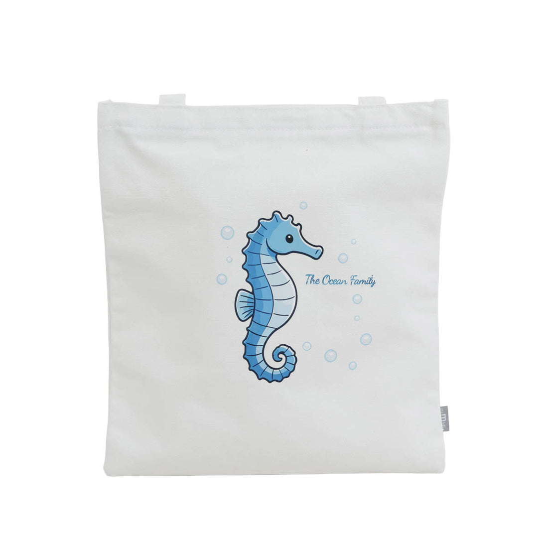 White canvas shoulder bag with blue seahorse graphic and bubbles on back panel