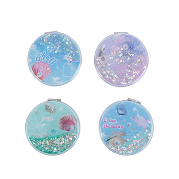 Blue round portable mirror with seashell glitter and "shell" text on the glass