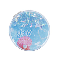 Blue round portable mirror with "shell" text and pink seashell with starfish accents