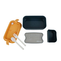 Orange lunch box with open lid; includes spoon and fork plus a detachable latch.