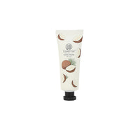 Coconut hand cream tube with illustrated shells and leaves, black screw cap