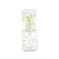 Travel empty spray bottle with clear body and green ocean print, spray pump top