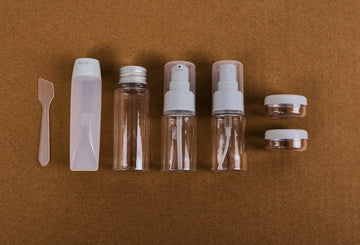 Travel empty bottle set with clear bottles and white caps, 7-piece