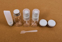 Travel empty bottle set with clear bottles, pump sprayers, and white lids