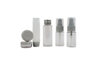 Travel empty bottle set with clear bottles and white caps in assorted sizes