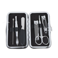 Open butterfly manicure set case with metal nail clippers, file, and tools.