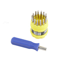 Mini screwdriver handle with metal tip and blue grip, with yellow-bit organizer behind