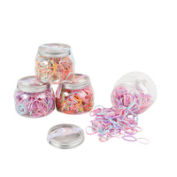 Set of clear canisters and loose pink, purple, and orange rubber bands