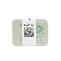 Mint green kids lunch box with cartoon graphics on the right side and side latch details