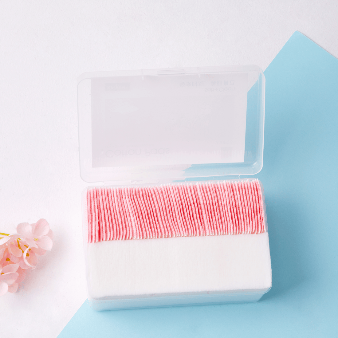 Blue case holding stacked white makeup remover pads with pink/red edge trim