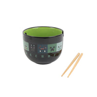 Black ramen bowl with green interior and pixel pattern, with light wood chopsticks