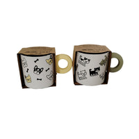 Two ceramic cups with cute animal icons in kraft boxes, cream handles visible
