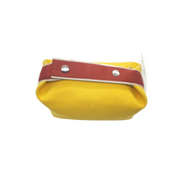 Yellow canvas bag with burgundy rim, silver snaps, and visible top opening