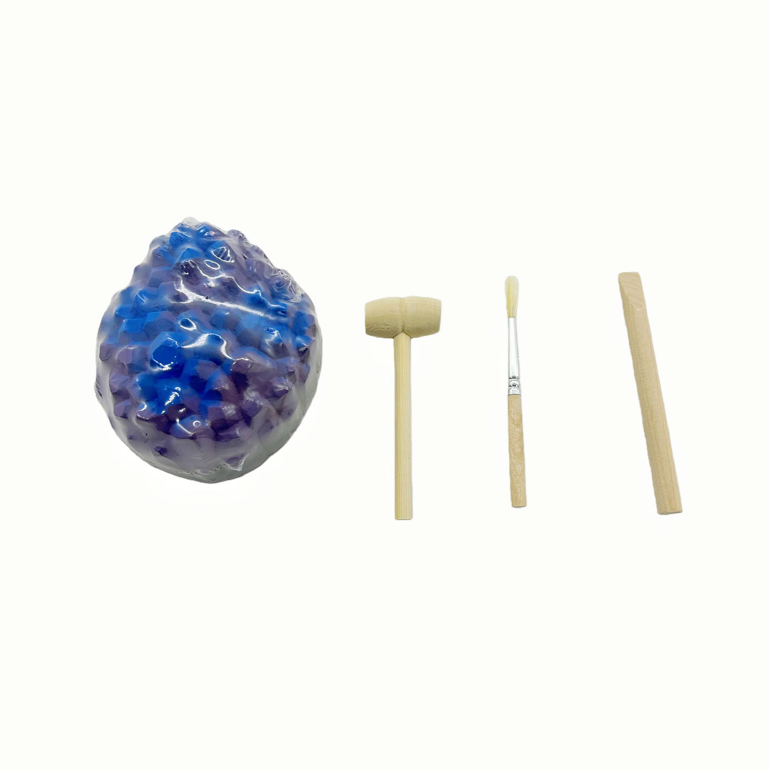 Purple and blue geode rock with wooden handle chisels and brush tools