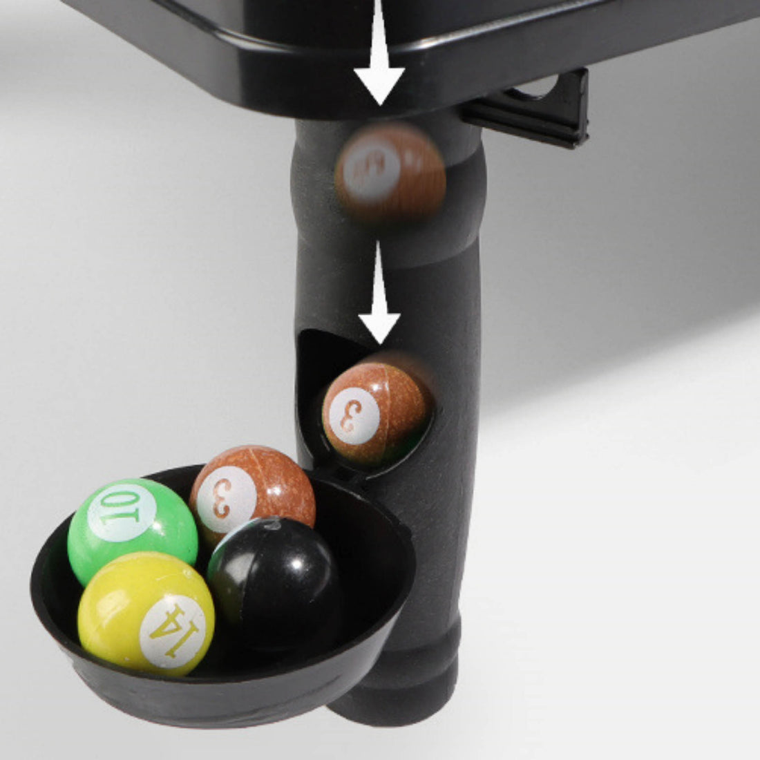 Mini pool table ball area close-up with numbered balls in black holder